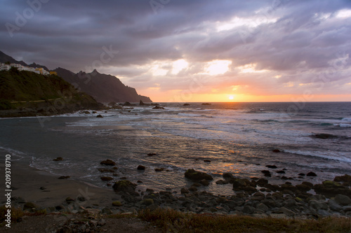 Sun setting in Atlantic ocean. View from Playa de Benijo, Tenerife Island photo