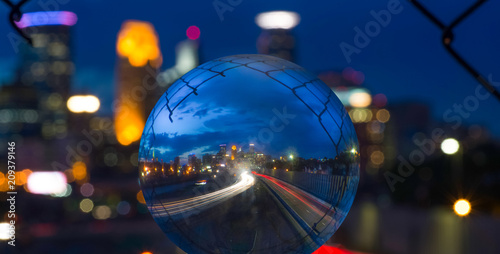 Twilight shot through glass ball of 24th Street pedestrian bridge, through the fencing over 35W highway Minneapolis Minnesota USA photo