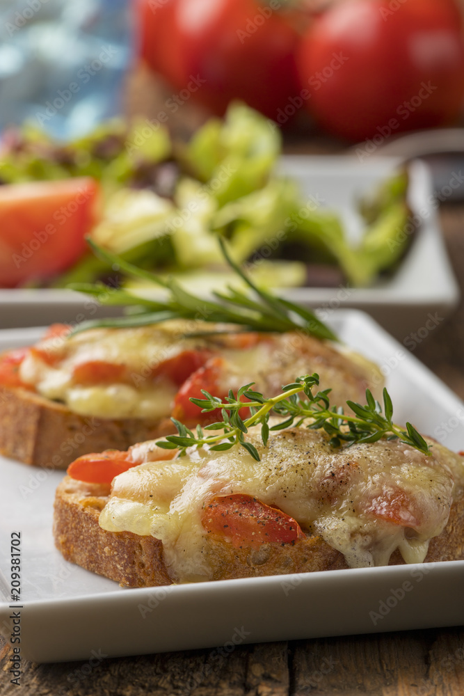 baguette with melted cheese and salad