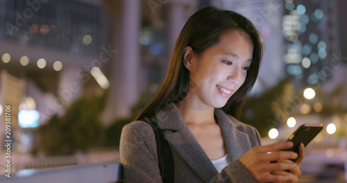 Photography Business woman use of cellphone at night