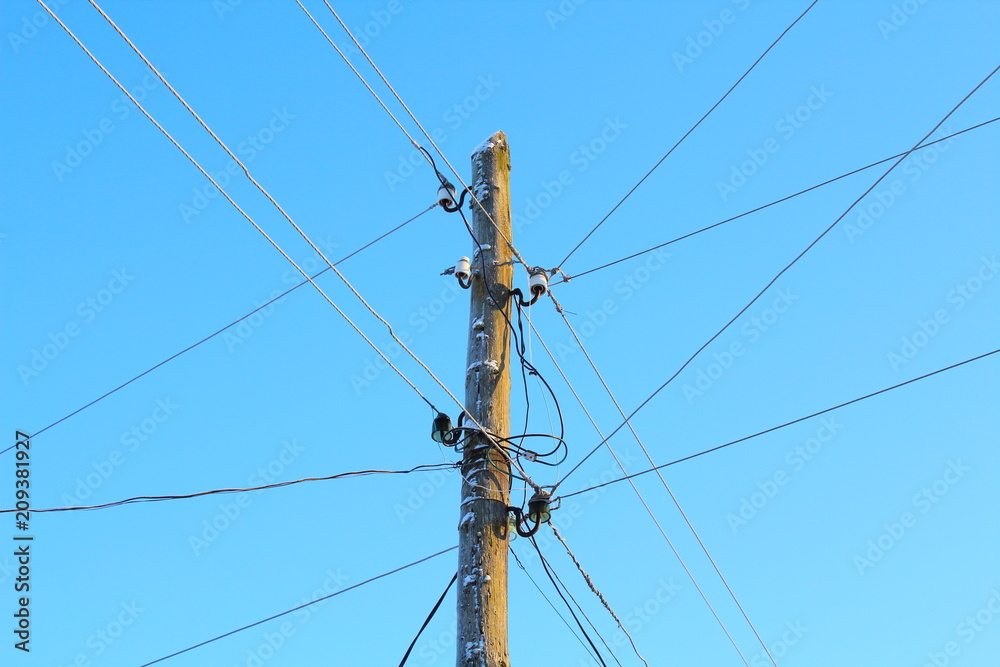 Wooden pole of power lines. A wooden pillar. Close-up. Countryside. Wooden pole of power lines. A wooden pillar. Close-up. Countryside.