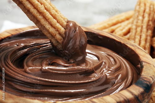 Traditional Spanish dessert churros with sugar and chocolate
