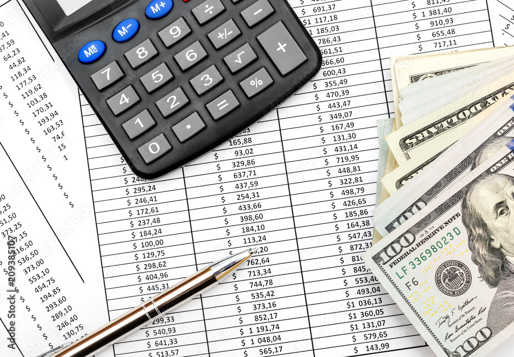 Pen, calculator and money on document with financial data. Top view. Pen, calculator and money on document with financial data. Top view.