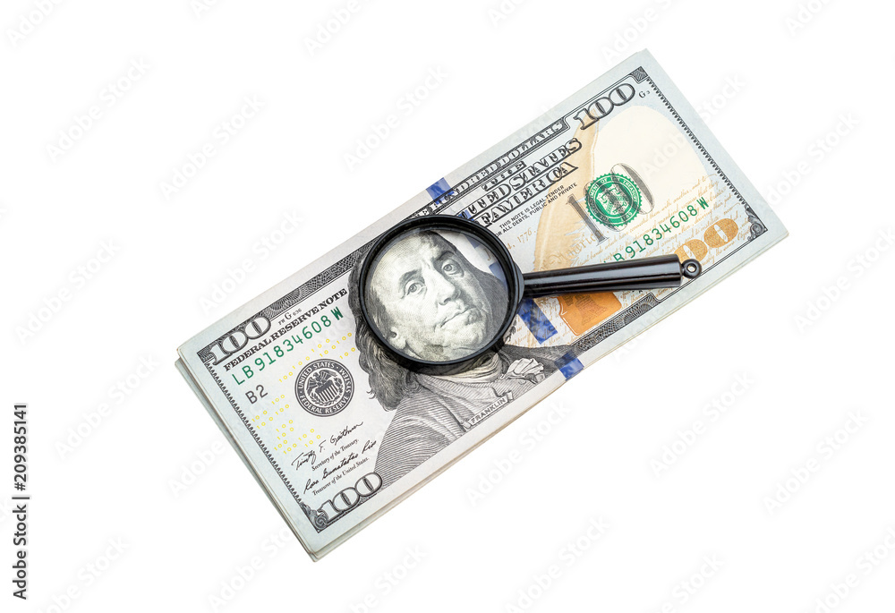 Magnifying glass with heap of money on white background. Top view. Magnifying glass with heap of money on white background. Top view.