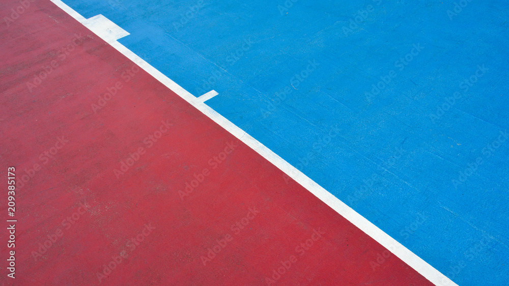 closeup blue and red concrete basketball court