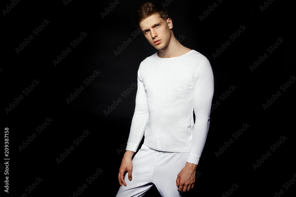 Male in white sport suit on black background Male in white sport suit on black background