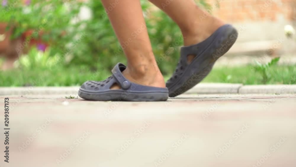 children's legs run along the pavement slow motion children's legs run along the pavement slow motion