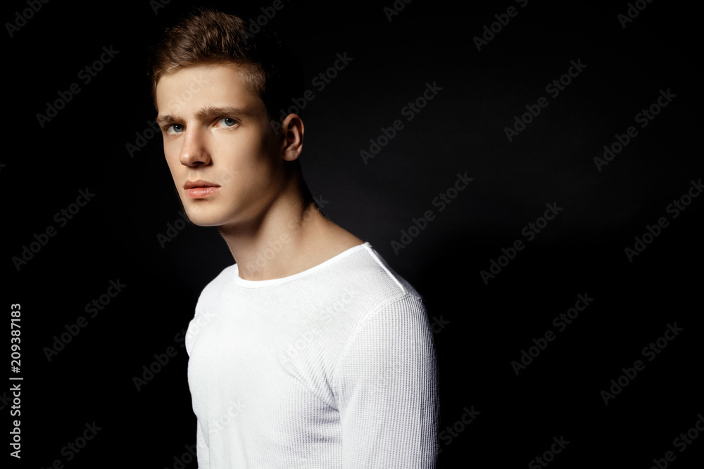 Male in white sport suit on black background