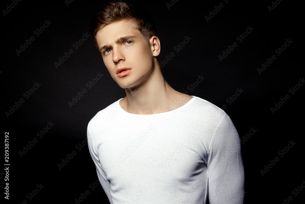 Naklejka premium Male in white sport suit on black background