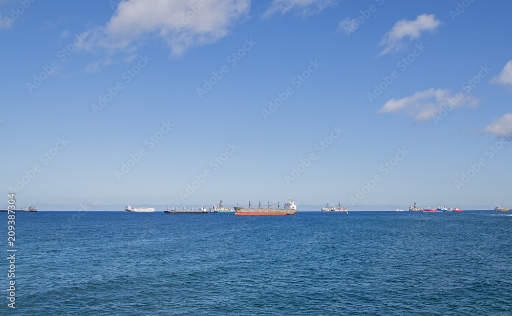 Blue sea with many ships in a sunny day.