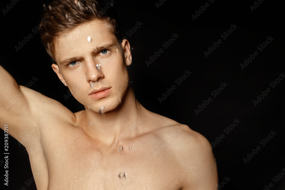 Wet guy portrait in water splash and drops Wet guy portrait in water splash and drops