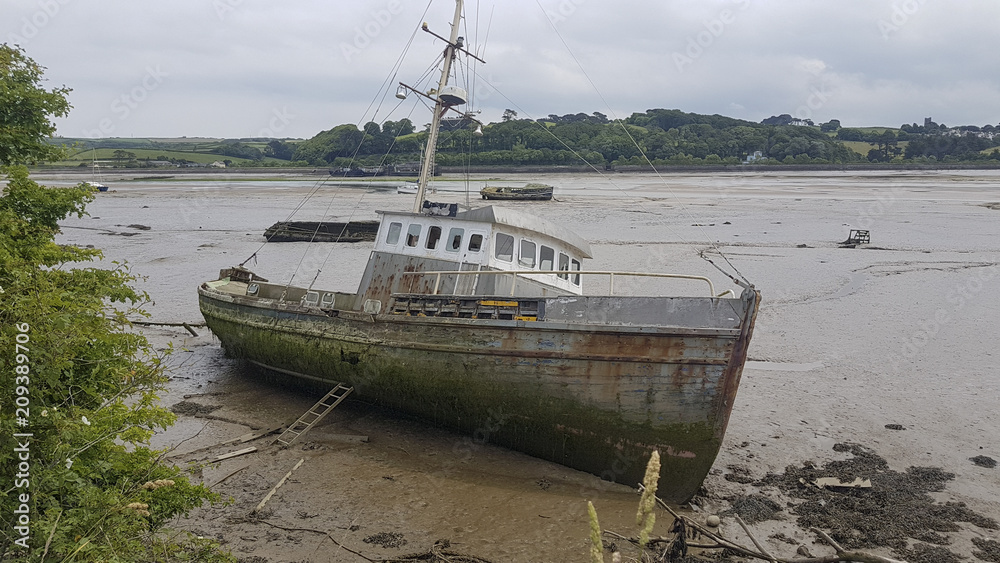 Old fishing vessels, boats, shipwrecked in the muddy estuary at Appledore North Devon United Kingdom Old fishing vessels, boats, shipwrecked in the muddy estuary at Appledore North Devon United Kingdom