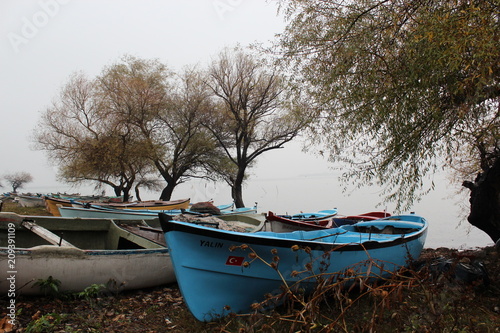 a blue fishing boat on the beach of Gölyazı Lake 