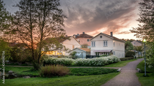 Fotografie, Obraz Sunset lights the houses in Molndal, suburb Gothenburg city, Sweden