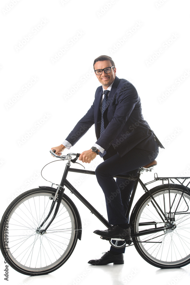 smiling businessman in eyeglasses sitting on bicycle isolated on white background smiling businessman in eyeglasses sitting on bicycle isolated on white background