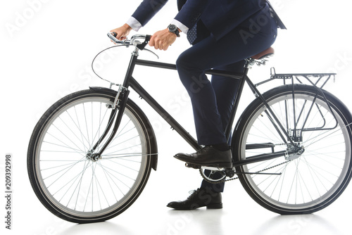 cropped image of businessman sitting on bicycle isolated on white background