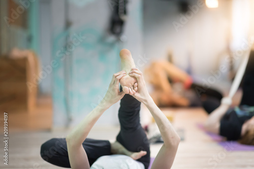 Young girl doing stretching indoors photo