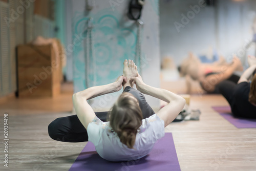 Young girl doing stretching indoors photo