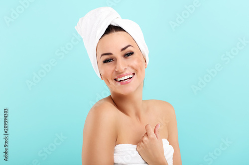 Spa skin care beauty woman with towel over blue background
