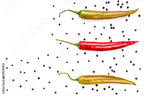 Red and green chilli peppers & black peppercorns, hot cooking spices, Isolated against a white background.