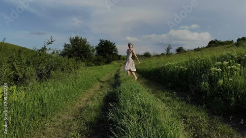 Cheerful young girl walking barefoot on a country road. Taken on Mavik Air 4k 100kbps photo