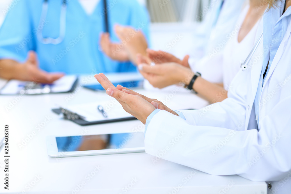 Group of doctors applauding at medical meeting. Close up of physician hands. Teamwork in medicine Group of doctors applauding at medical meeting. Close up of physician hands. Teamwork in medicine