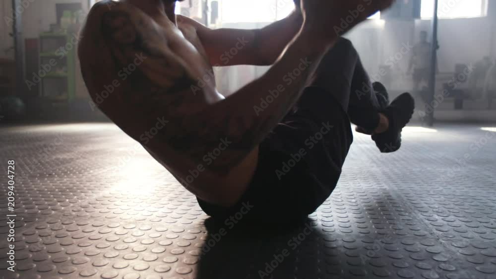Man doing exercise with medicine ball
