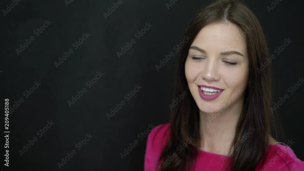Young woman smiling at black background with teeth for stomatology Young woman smiling at black background with teeth for stomatology