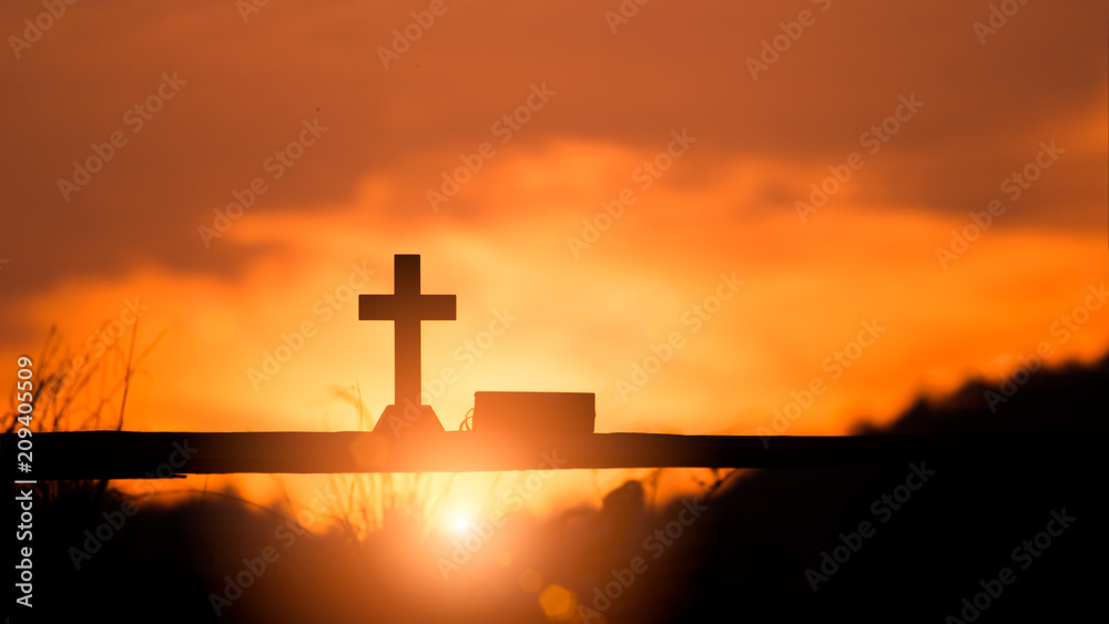 Cross with bible holy on wooden at sunset background. christian concept.