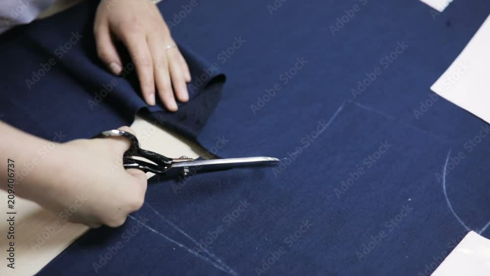 Dressmaker cutting fabric. Girl customize template