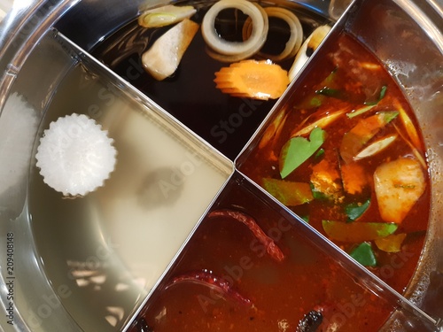 Thai hotpot shabu ,four style of shabu soup tom yum ,pork ,shoyu and Sichuan pepper soup. photo