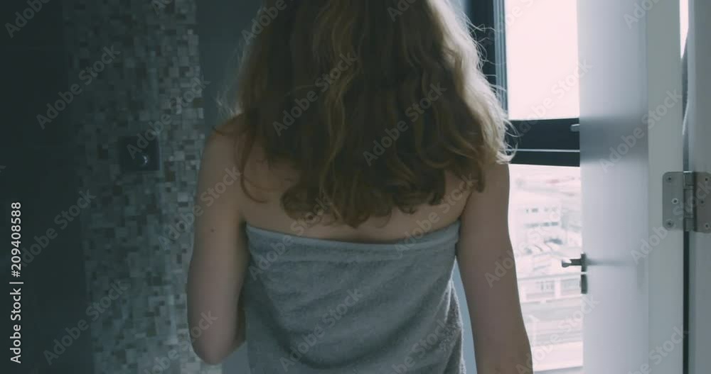 Young woman enetering her en suite in city apartment