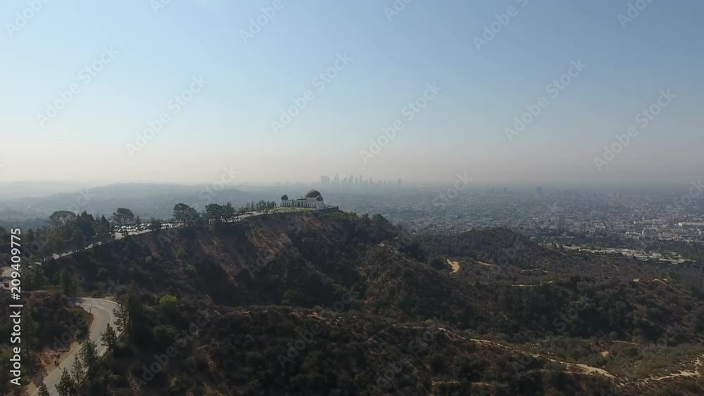 Griffith Observatory with drone flying towards downtown Los Angeles. Griffith Observatory with drone flying towards downtown Los Angeles.
