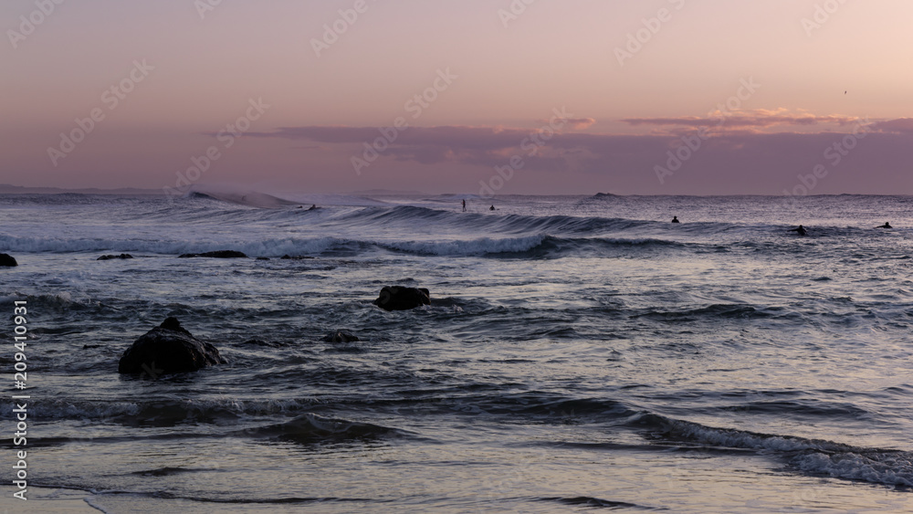 Obraz premium surfers with an early morning sky