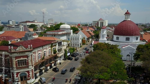 Flying towards Dutch colonial church and old warehouses in Semarang, Indonesia photo