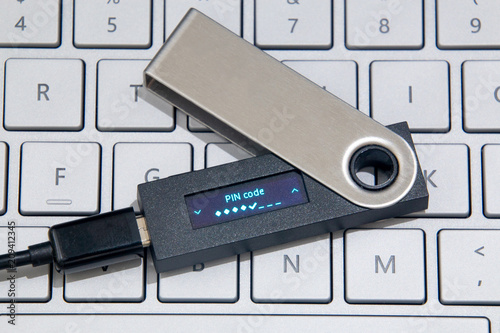 Cryptocurrency Hardware Wallet On Laptop Keyboard
