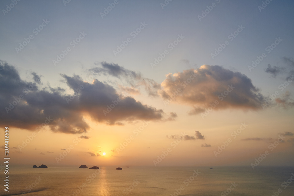 View from the top of the mountain to the sea and the islands against colourful tropical sunset