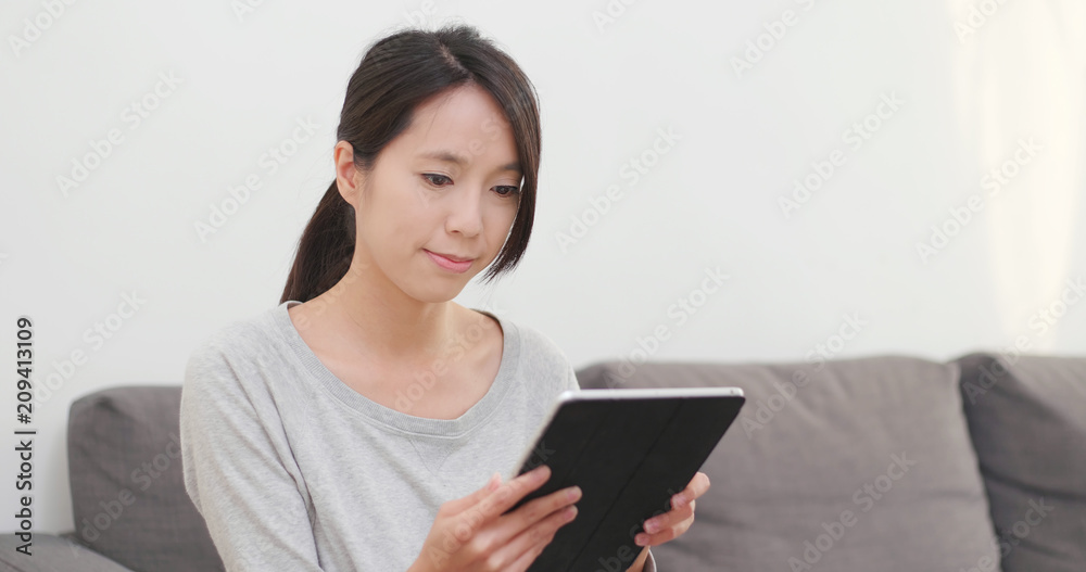 Woman use of tablet computer at home Woman use of tablet computer at home