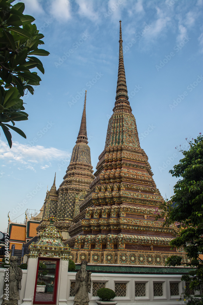 Fototapeta premium Pagoda is in Wat Pho that was named as the temple of the pagoda or chedi that are decorated with yellow glaze or glazed tiles or dark blue. 
