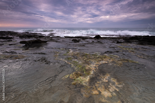 Coastline rock shelf alongside the iconic Great Ocean Road in Australia at sunrise