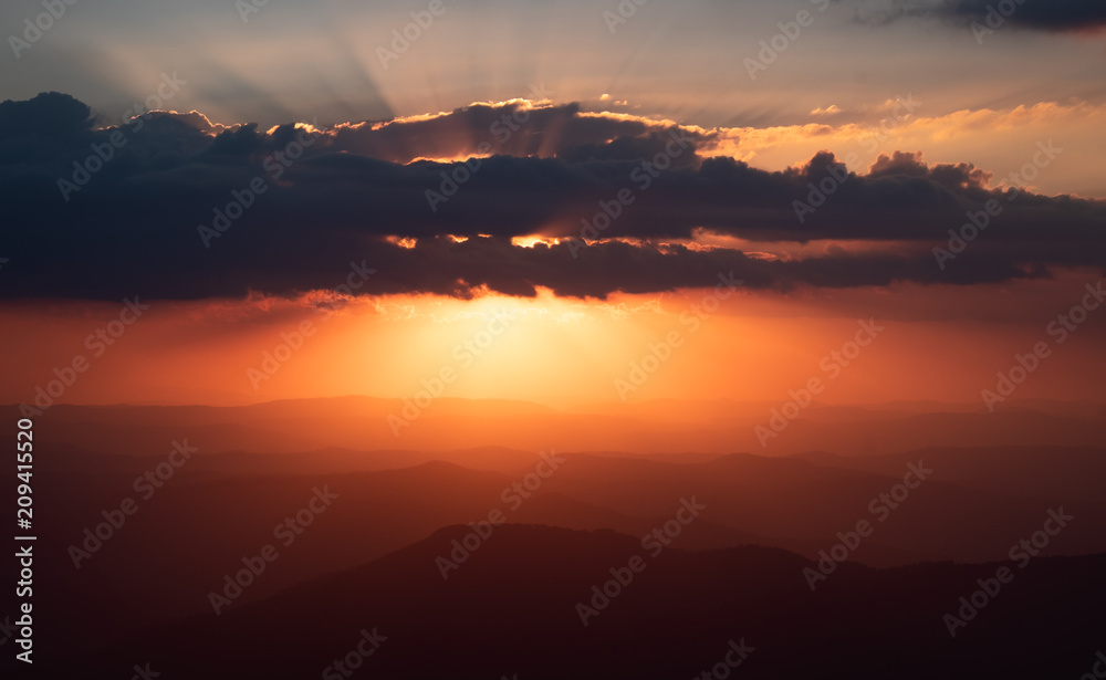 Sunset as viewed from Australia's highest mountain peak, Mt Kosciuszko. The Victorian high country can be seen in the distance.
