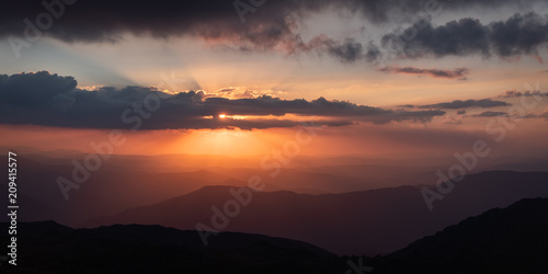 Sunset as viewed from Australia's highest mountain peak, Mt Kosciuszko. The Victorian high country can be seen in the distance.