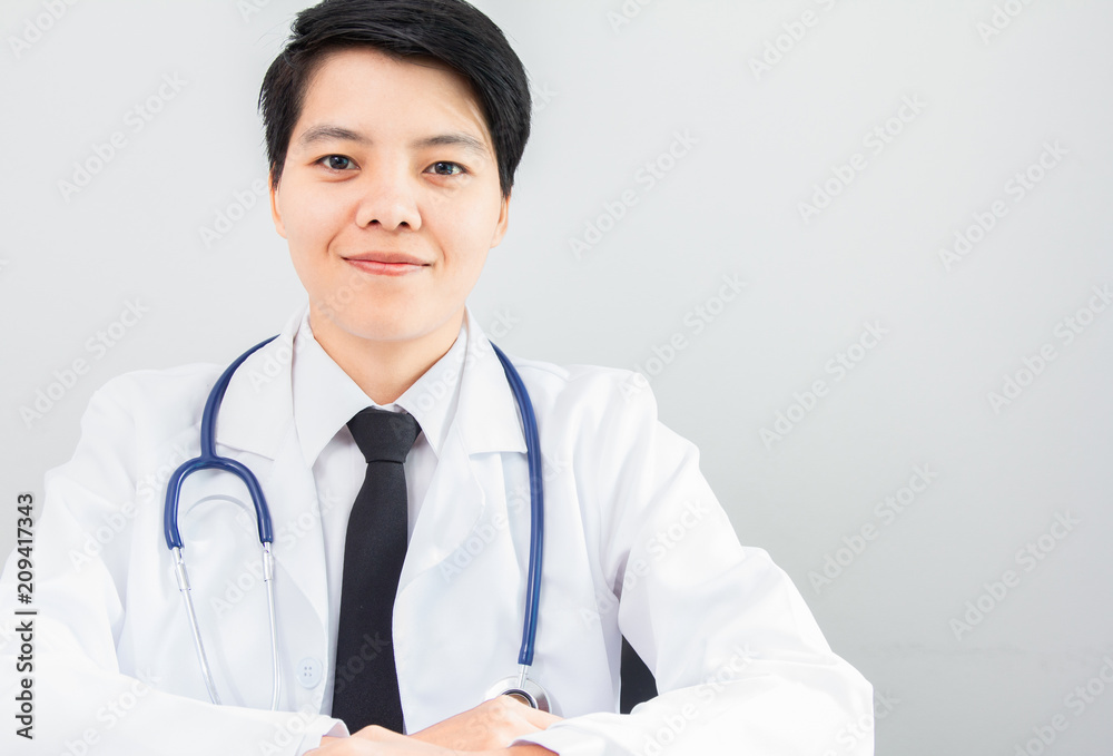 Homosexuality of asian doctor woman smiling and sitting on chair look to camera with stethoscope on gray background. Homosexuality of asian doctor woman smiling and sitting on chair look to camera with stethoscope on gray background.