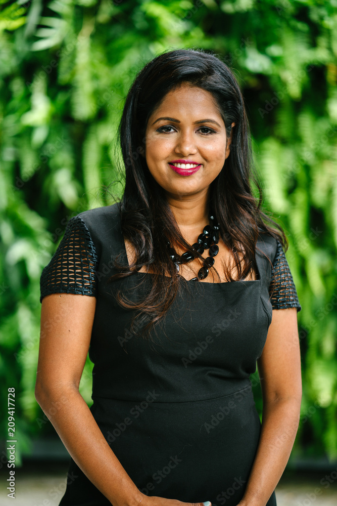 A head shot portrait of a successful Indian Asian businesswoman striking a very elegant pose. She is wearing a black dress and looks very confident and sophisticated. A head shot portrait of a successful Indian Asian businesswoman striking a very elegant pose. She is wearing a black dress and looks very confident and sophisticated.