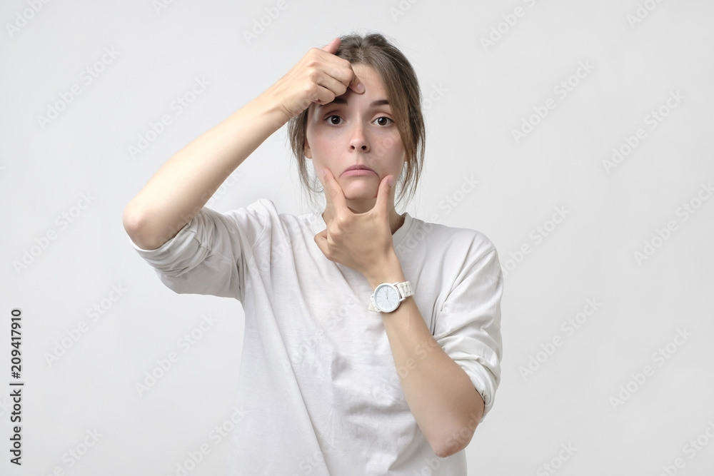 Pretty caucasian woman pulling a smile on her face. Concept of loss of work or being alone Pretty caucasian woman pulling a smile on her face. Concept of loss of work or being alone