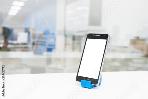 Mock up of Black mobile phone on phone holder