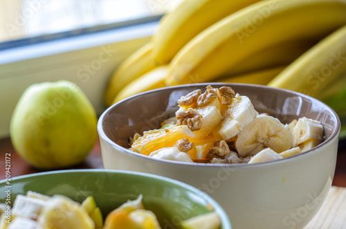Healthy Breakfast Bowl: Oatmeal with Banana, Orange, Green Apple, Walnuts, Sesame and Chia Seeds