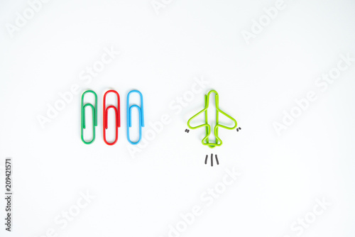 Business concept for group of stacked paperclip with another one green plane paperclip is point to another direction as a team leadership