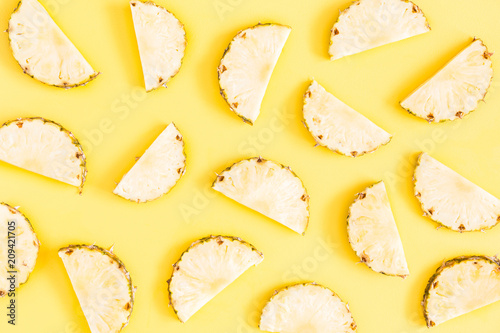 Pineapples on yellow background. Summer concept. Flat lay, top view