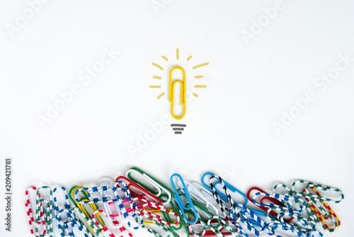 Minimal flat lay for group of paper clip with another individual paper clip standing alone on the difference location for team leader and difference thinking concept photo